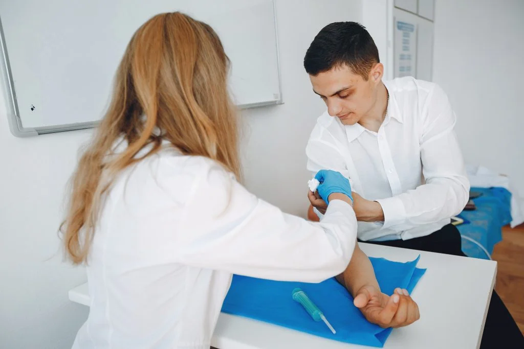 Man and woman take blood for analysis..Students practice medicine.Nurse perform procedures.